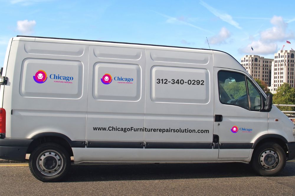 A side view of a white delivery van displaying the logo and contact details for Chicago Furniture Repair Solution.